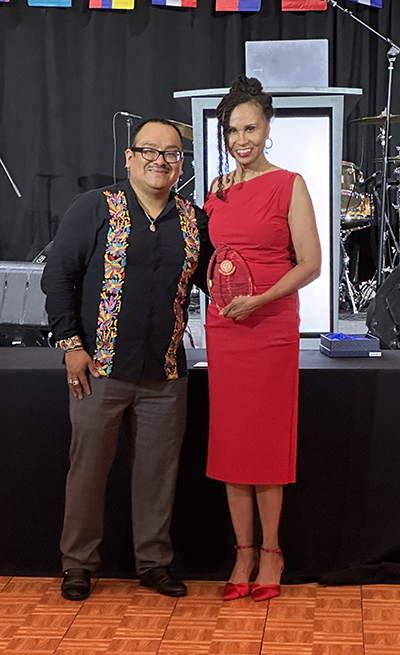 Cheryl Dickson, MD, MPH, accepts the Warrior Hero Award from El Concilio CEO Adrian Vazquez