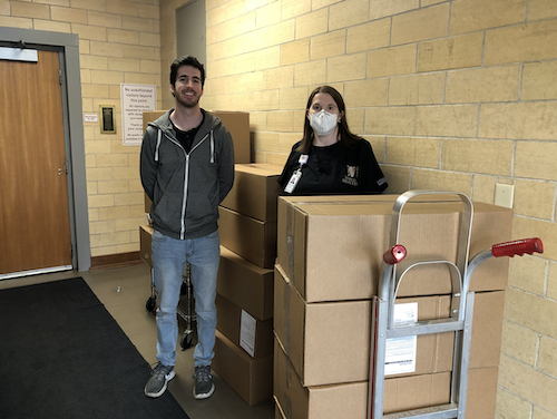 M3 Josh White is pictured with Robin Scott, the medical school’s Occupational Health Manager, and a donation of 1,600 face shields.