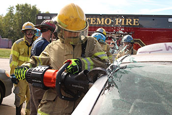 Student using extrication equipment during MFR Capstone Day 2025