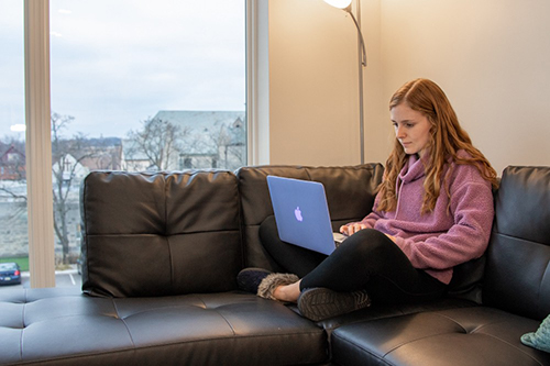 First-year medical student Jessica Edwards sits on her couch as she reviews a lecture at her apartment.