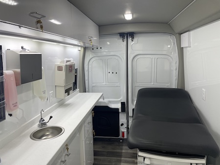 The inside of the mobile unit has an exam table and other areas for private interviews.