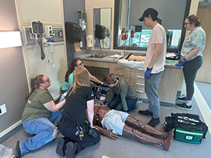 The WMed EMS Fellow discussing cardiac arrest management with a group of students at Kalamazoo Valley Community College